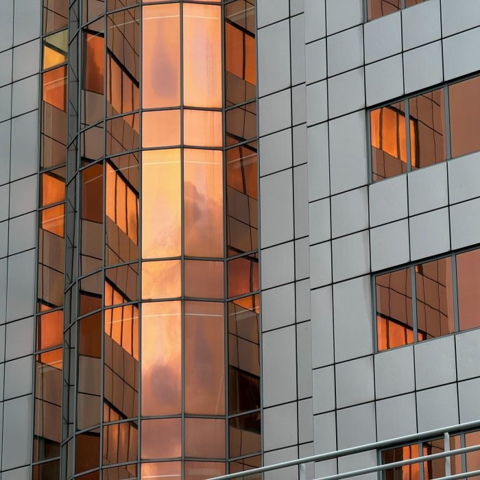 Modern Building with Reflective Orange-Tinted Windows Modern Building with Reflective Orange-Tinted Windows
